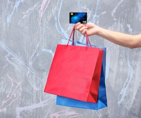 Holding a shopping bag with a bank card for a woman Stock Photo 06