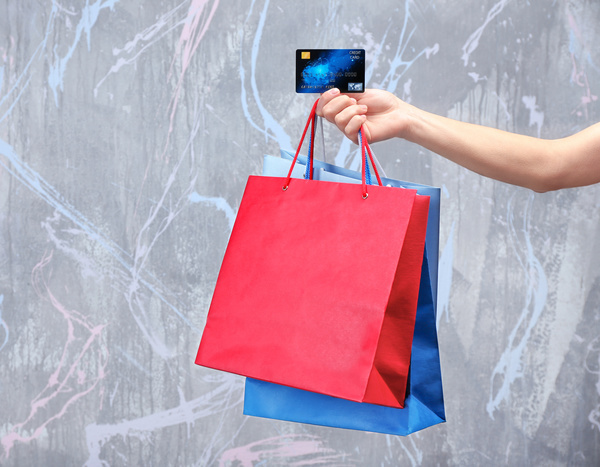 Holding a shopping bag with a bank card for a woman Stock Photo 06