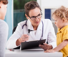 Pediatric female doctor to the child to see a doctor Stock Photo