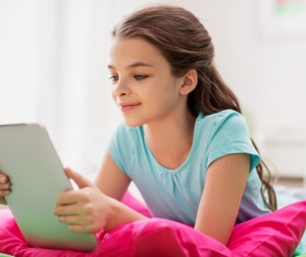 Play the little girl on the tablet Stock Photo
