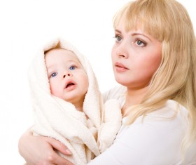 The young mother holds the baby wrapped in a blanket Stock Photo 01