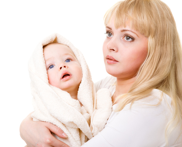 The young mother holds the baby wrapped in a blanket Stock Photo 01