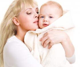 The young mother holds the baby wrapped in a blanket Stock Photo 02