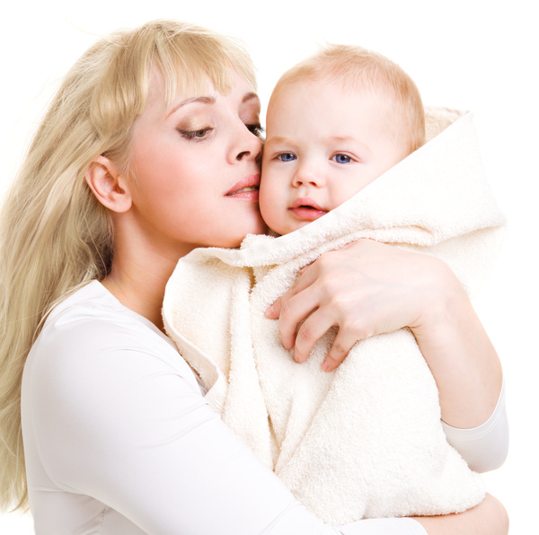 The young mother holds the baby wrapped in a blanket Stock Photo 02