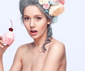 Wearing garland girl holding pastry Stock Photo