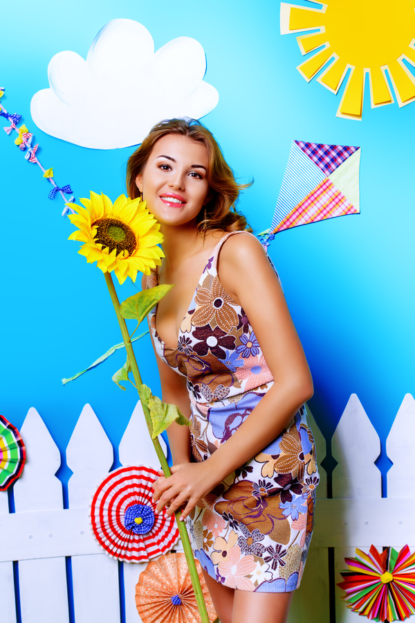 Beautiful woman holding a sunflower Stock Photo