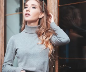 Beautiful woman standing in front of glass Stock Photo