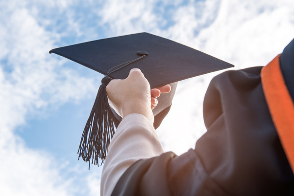 Degree graduates holding cap Stock Photo 02