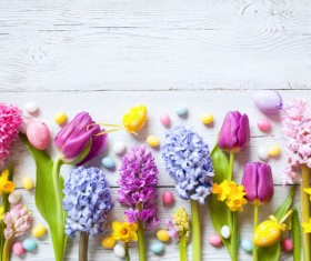 Easter wooden background with eggs, candy and flowers Stock Photo 04