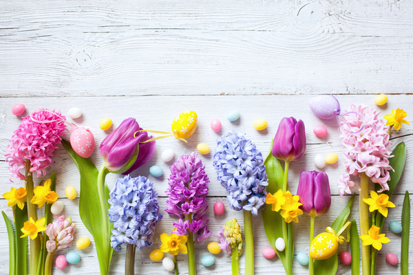 Easter wooden background with eggs, candy and flowers Stock Photo 04