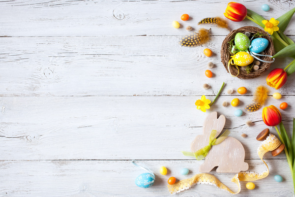 Easter wooden background with eggs, candy and flowers Stock Photo 05