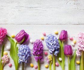 Easter wooden background with eggs, candy and flowers Stock Photo 06