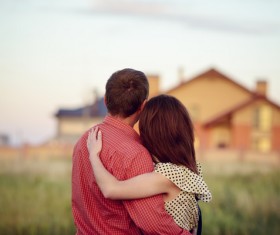 Embracing couple looking at new homes Stock Photo