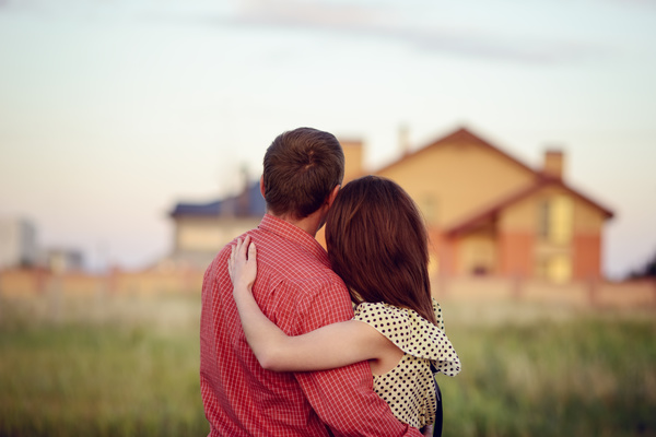 Embracing couple looking at new homes Stock Photo