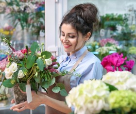 Flower shop work woman holding flowers Stock Photo