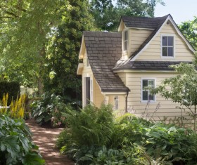 Flowers and trees surrounding the cottage Stock Photo