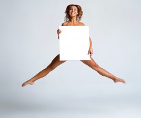 Girl holding a blank paper jumped high Stock Photo 01