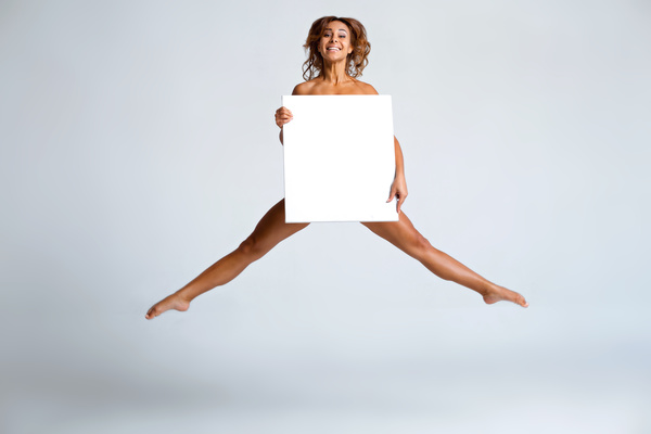 Girl holding a blank paper jumped high Stock Photo 01