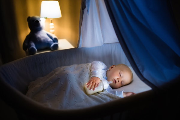 Holding a bottle of baby to sleep Stock Photo