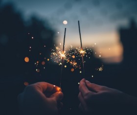 Holding burning fireworks Stock Photo