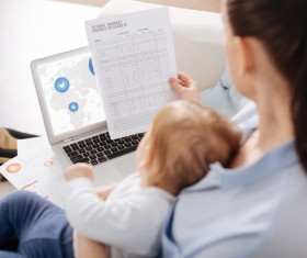 Holding the baby's mother looking at the business report HD picture