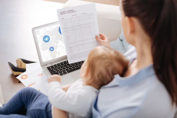 Holding the baby's mother looking at the business report HD picture