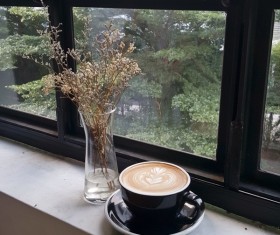 Latte coffee and bottles on the windowsill flower Stock Photo