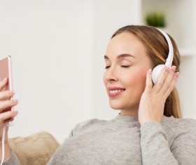 Listening to music with headphones and smartphone Stock Photo