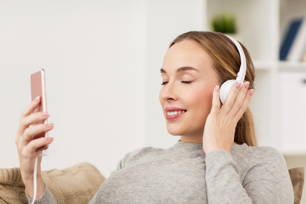 Listening to music with headphones and smartphone Stock Photo