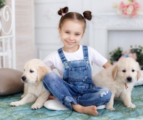 Little girl with two puppies Stock Photo