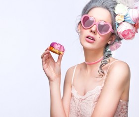 Lovely girl with heart glasses eating macarons Stock Photo