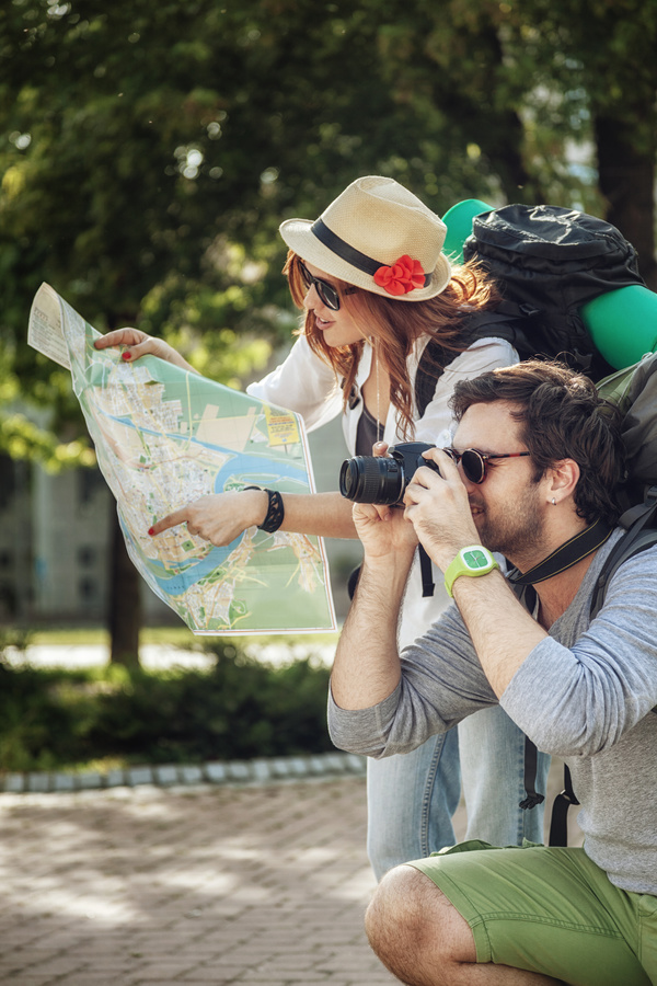 Maps and signs pointing tourists taking pictures Stock Photo