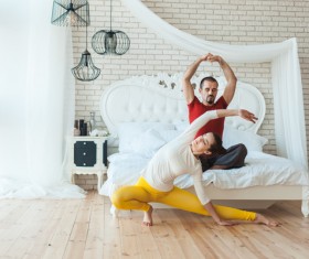 Men and women practicing yoga at home Stock Photo 01