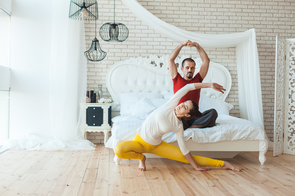 Men and women practicing yoga at home Stock Photo 01