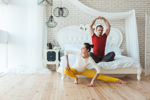 Men and women practicing yoga at home Stock Photo 02
