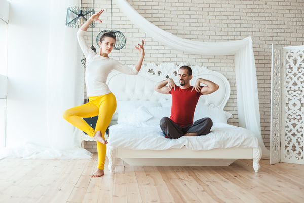 Men and women practicing yoga at home Stock Photo 03