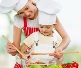 Mom and her daughter mix salad Stock Photo