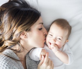Mother kissing newborn HD picture