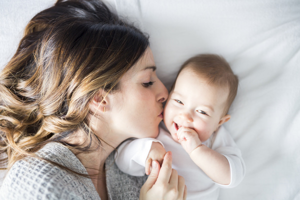 Mother kissing newborn HD picture