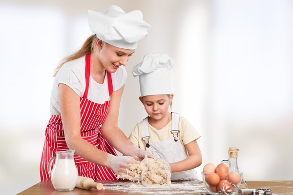 Mother taught her daughter to knead Stock Photo