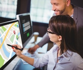 Office colleagues to view the electronic map on the computer Stock Photo