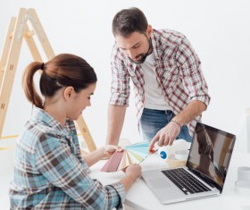 Pick the color card of the couple and the computer on the desk Stock Photo