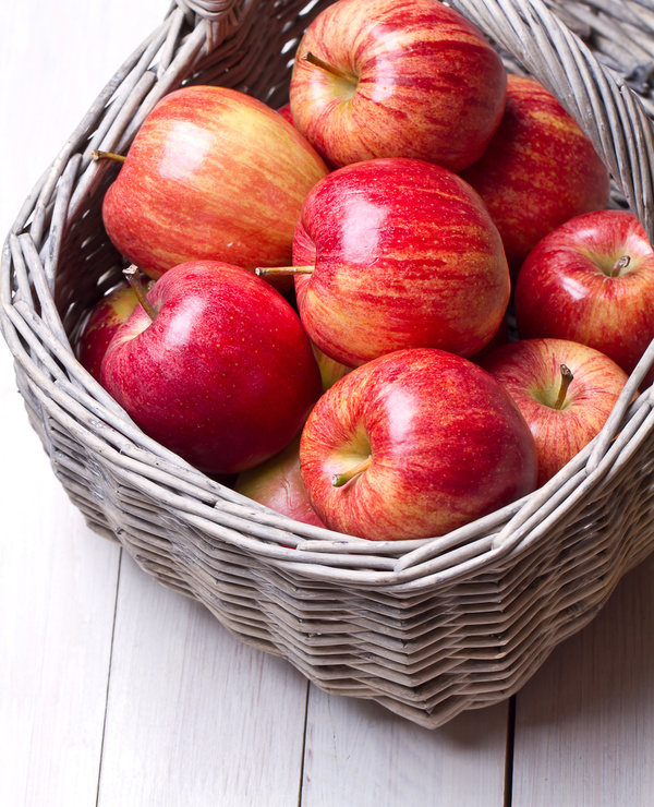 Red apple placed in the basket Stock Photo