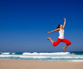 Seaside jumping woman HD picture
