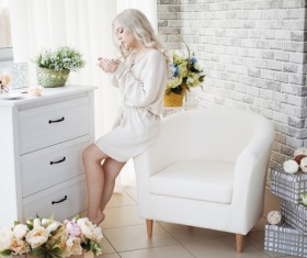 Sitting on a sofa arm with a decorated room with flowers HD picture