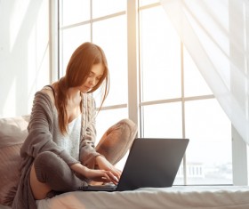 Sitting on the windowsill with a computer typing chat girl HD picture