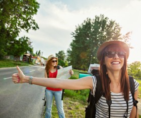 Smiling girl hitchhiking Stock Photo