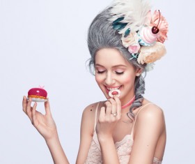 Smiling girl holding a fine pastry Stock Photo