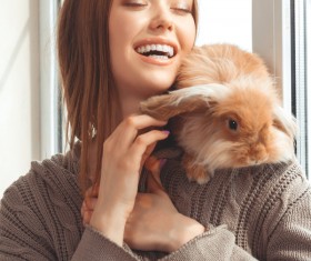 Smiling girl with pet rabbit HD picture