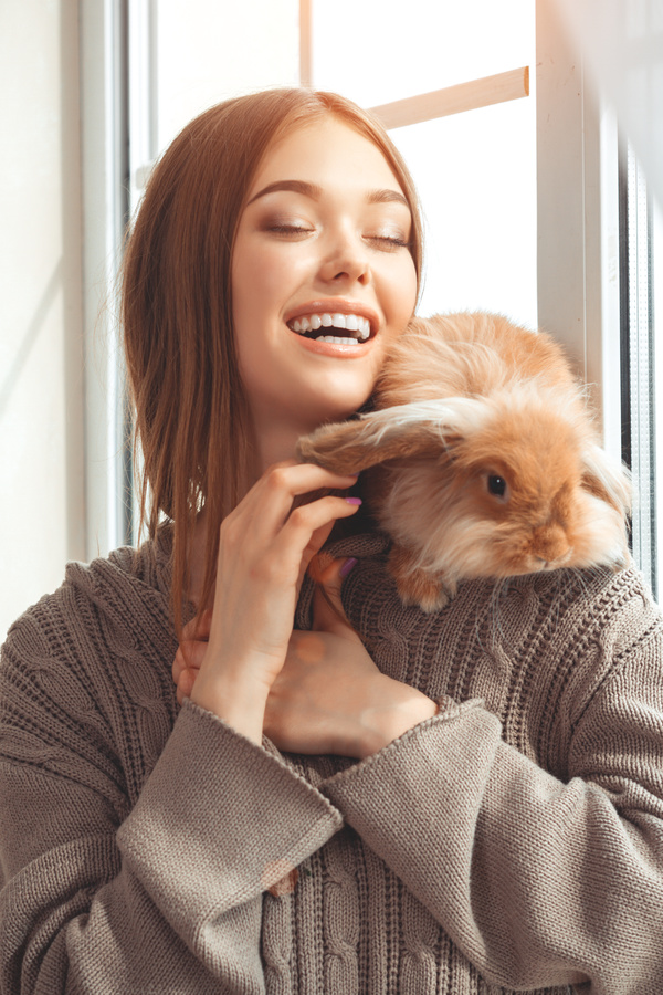 Smiling girl with pet rabbit HD picture